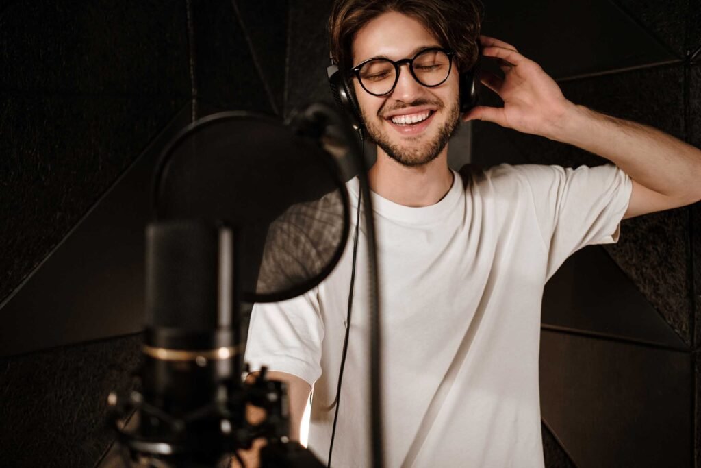young-attractive-male-singer-in-headphones-joyfull-PGDEZ8B.jpg